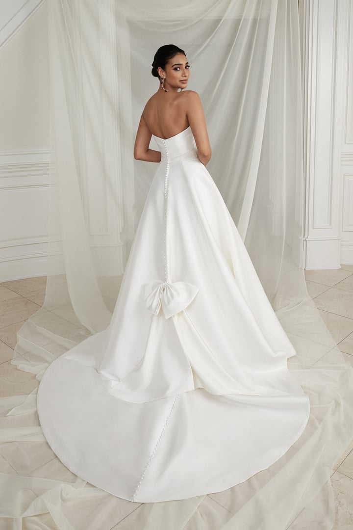 Justin Alexander Estelle back view with bow